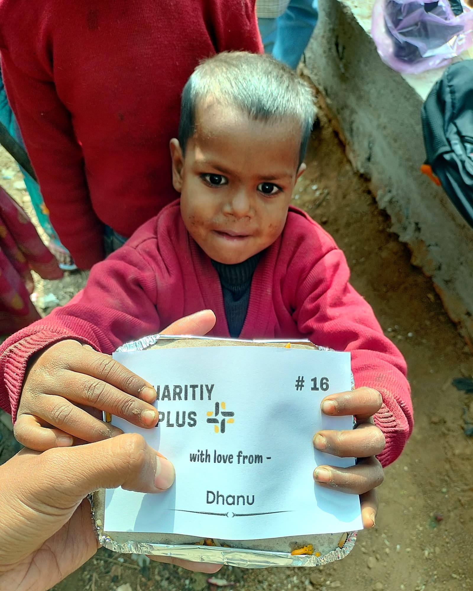 A young boy holds his food packet, #16